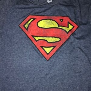 A medium in men’s Superman shirt